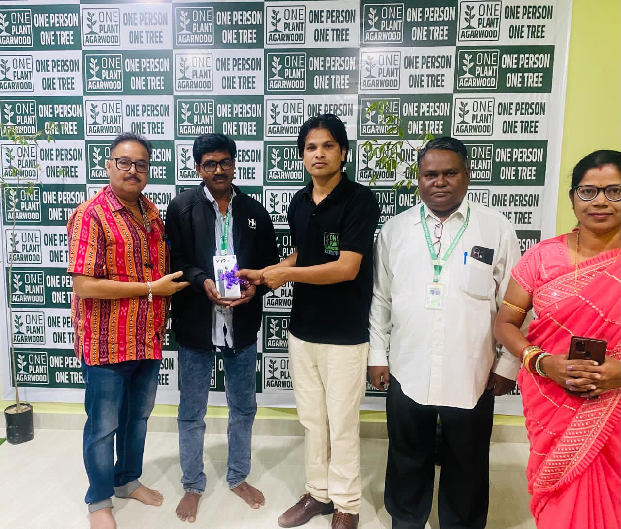 Farmer planting agarwood saplings