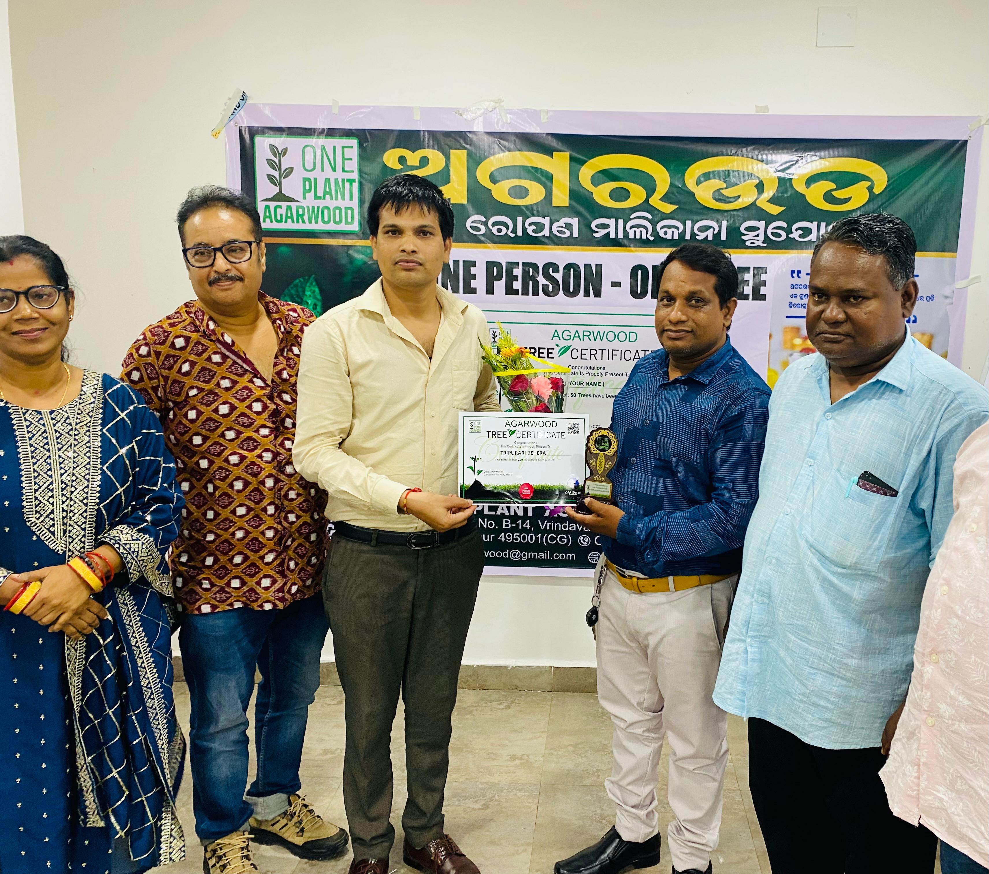 Farmer planting agarwood saplings