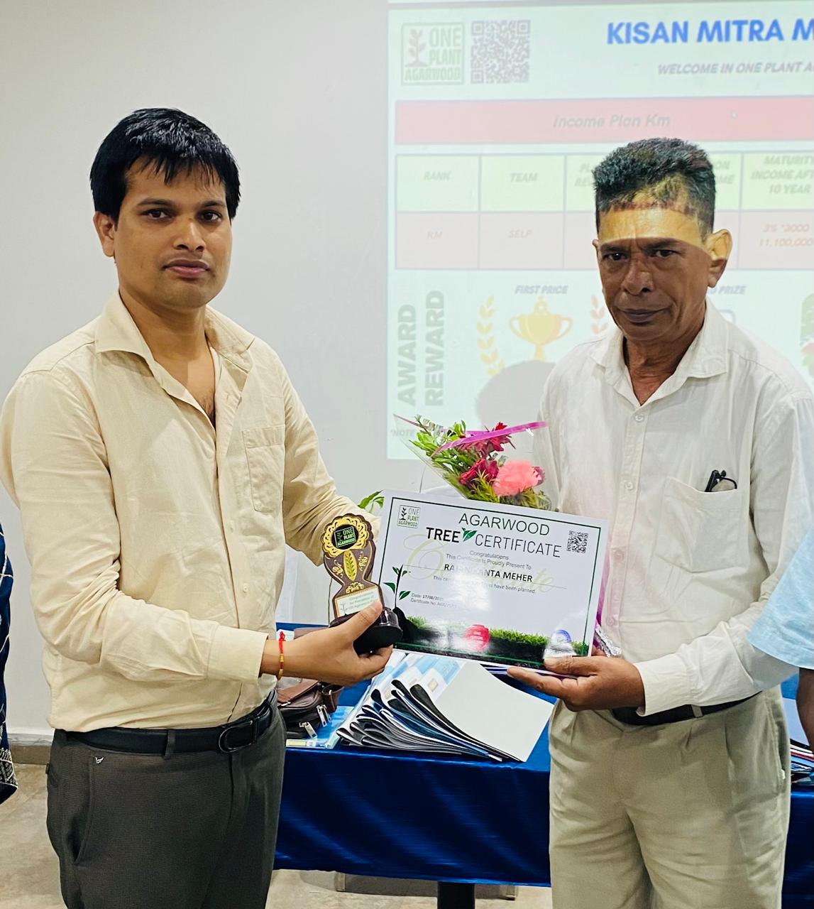 Farmer planting agarwood saplings