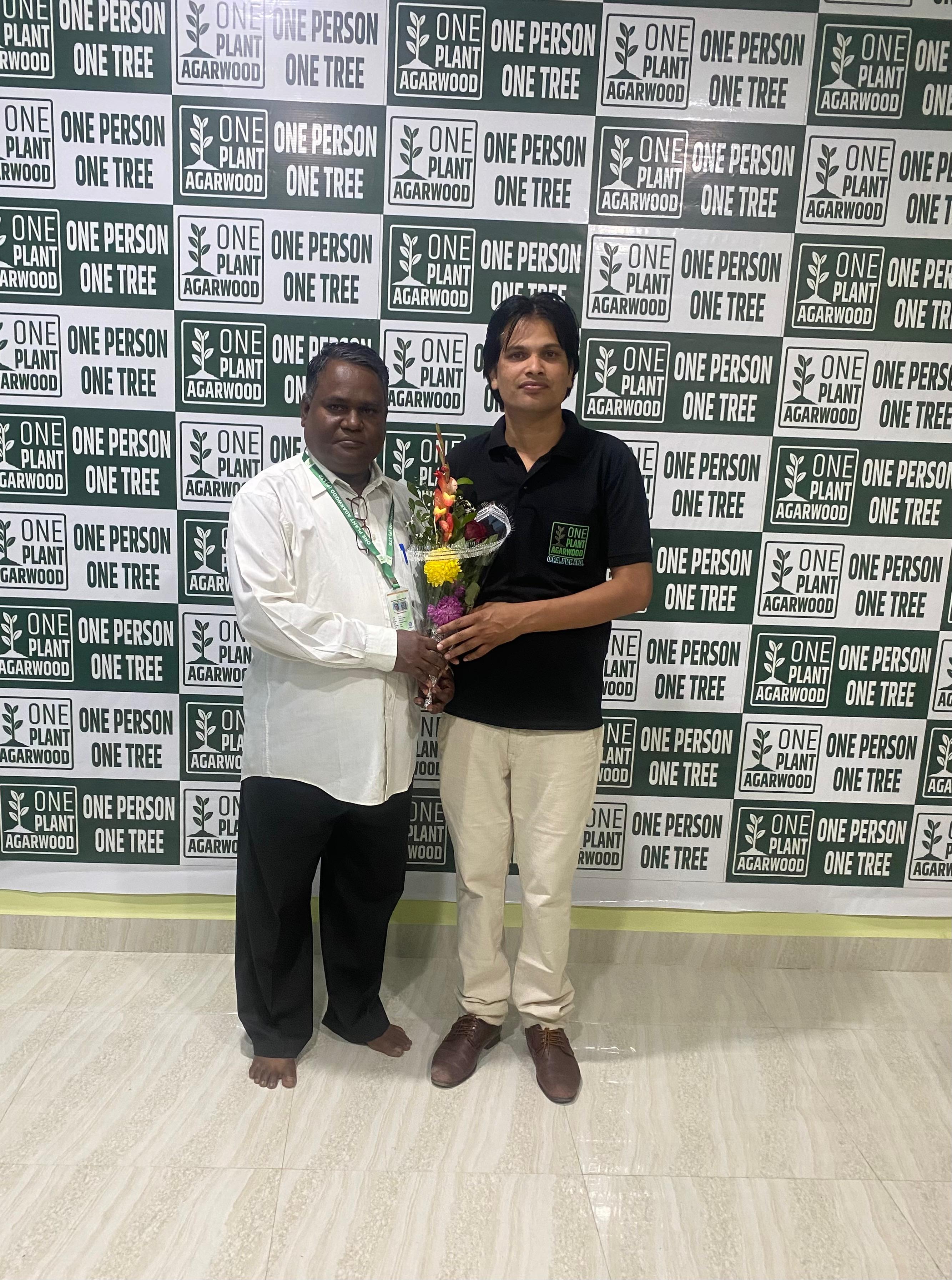 Farmer planting agarwood saplings